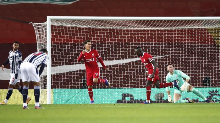 LIVERPOOL, ENGLAND - DECEMBER 27: Sadio Mane of Liverpool celebrates with teammate Roberto Firmino after scoring their teams first goal during the Premier League match between Liverpool and West Bromwich Albion at Anfield on December 27, 2020 in Liverpool, England. A limited number of fans (2000) are welcomed back to stadiums to watch elite football across England. This was following easing of restrictions on spectators in tiers one and two areas only. (Photo by Clive Brunskill/Getty Images)