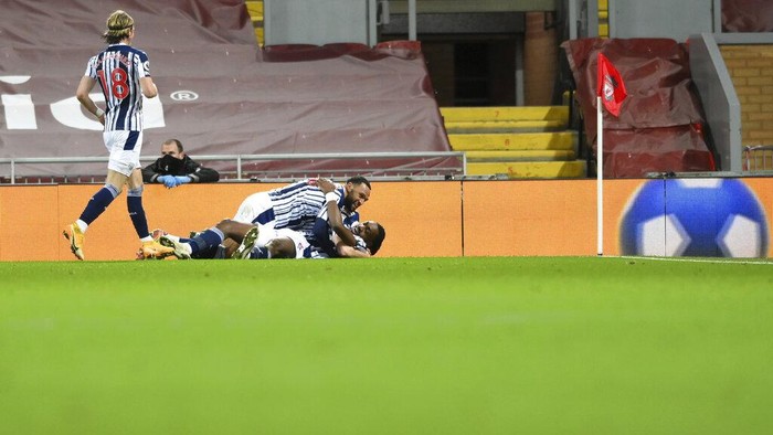 West Bromwich Albions Semi Ajayi celebrates with team mates after scoring his sides first goal during an English Premier League soccer match between Liverpool and West Bromwich Albion at the Anfield stadium in Liverpool, England, Sunday Dec. 27, 2020. (Stu Forster/Pool via AP)