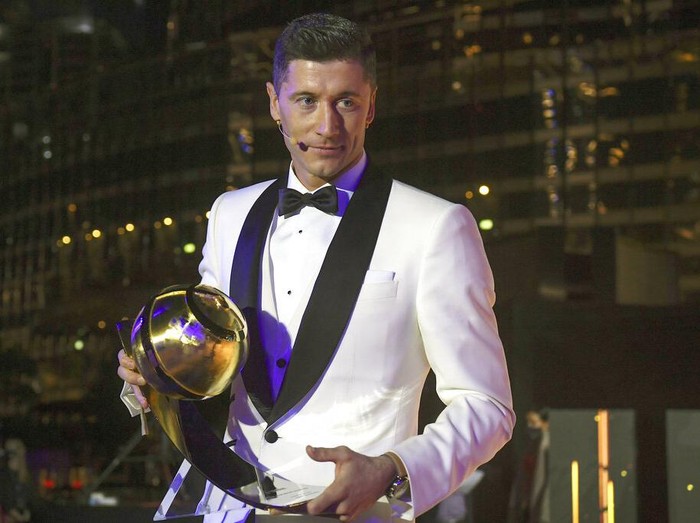 Robert Lewandowski holds the trophy for best player of the year, at the Dubai Globe Soccer Awards ceremony in Dubai, United Arab Emirates, Sunday, Dec. 27, 2020. (Fabio Ferrari/LaPresse via AP)