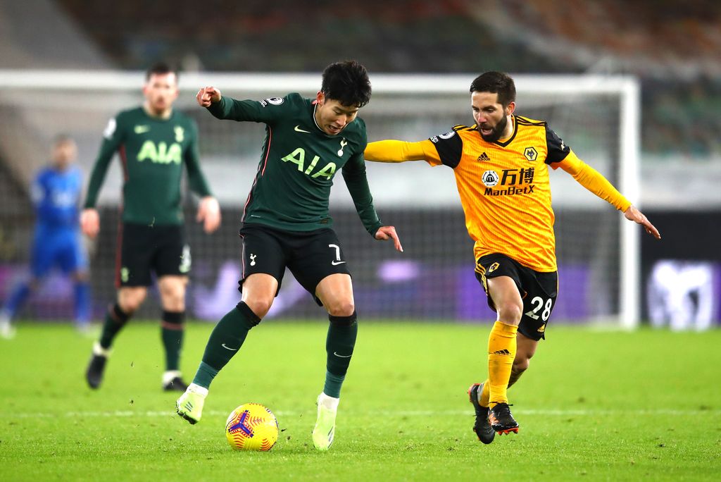 WOLVERHAMPTON, ENGLAND - DECEMBER 27: Son Heung-Min of Tottenham Hotspur is challenged by Joao Moutinho of Wolverhampton Wanderers during the Premier League match between Wolverhampton Wanderers and Tottenham Hotspur at Molineux on December 27, 2020 in Wolverhampton, England. The match will be played without fans, behind closed doors as a Covid-19 precaution. (Photo by Michael Steele/Getty Images)