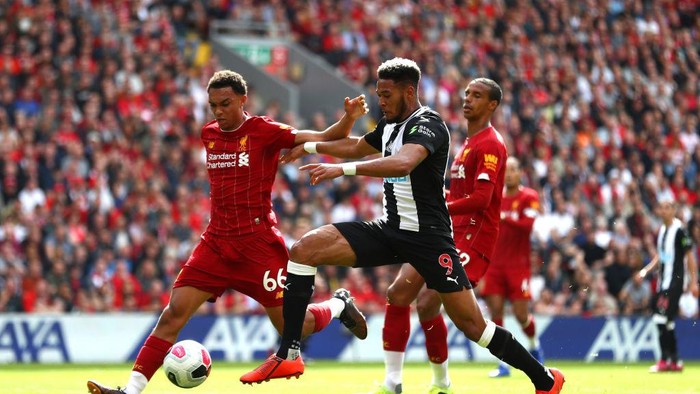 LIVERPOOL, ENGLAND - SEPTEMBER 14: Joelinton of Newcastle United is closed down by Trent Alexander-Arnold of Liverpool  during the Premier League match between Liverpool FC and Newcastle United at Anfield on September 14, 2019 in Liverpool, United Kingdom. (Photo by Michael Steele/Getty Images)