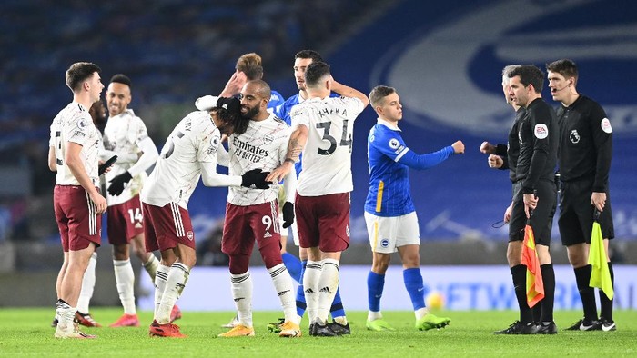 BRIGHTON, ENGLAND - DECEMBER 29: Mohamed Elneny,  Alexandre Lacazette and Granit Xhaka of Arsenal celebrate following their sides victory in the Premier League match between Brighton & Hove Albion and Arsenal at American Express Community Stadium on December 29, 2020 in Brighton, England. The match will be played without fans, behind closed doors as a Covid-19 precaution. (Photo by Neil Hall - Pool/Getty Images)