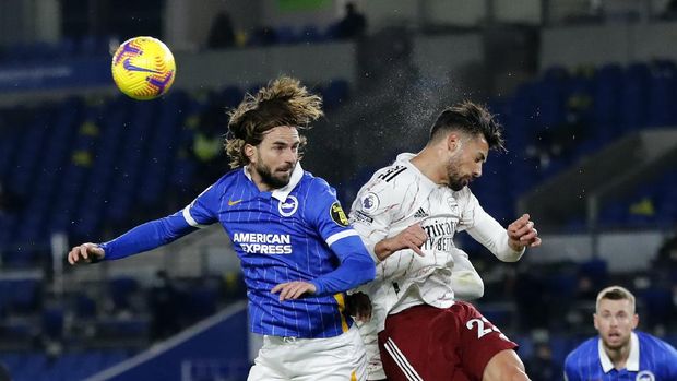 Brighton's Davy Proepper, left, jumps for a header with Arsenal's Pablo Mari the English Premier League soccer match between Brighton and Arsenal at the Falmer stadium in Brighton, England, Tuesday, Dec. 29, 2020. (AP Photo/Frank Augstein, Pool)