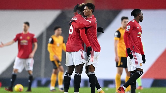 MANCHESTER, ENGLAND - DECEMBER 29: Paul Pogba and Marcus Rashford of Manchester United celebrate following their teams victory in the Premier League match between Manchester United and Wolverhampton Wanderers at Old Trafford on December 29, 2020 in Manchester, England. The match will be played without fans, behind closed doors as a Covid-19 precaution. (Photo by Laurence Griffiths/Getty Images)