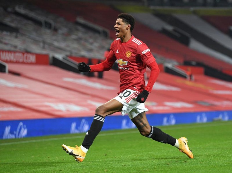 MANCHESTER, ENGLAND - DECEMBER 29: Marcus Rashford of Manchester United celebrates after scoring his team's first goal during the Premier League match between Manchester United and Wolverhampton Wanderers at Old Trafford on December 29, 2020 in Manchester, England. The match will be played without fans, behind closed doors as a Covid-19 precaution. (Photo by Michael Regan/Getty Images)