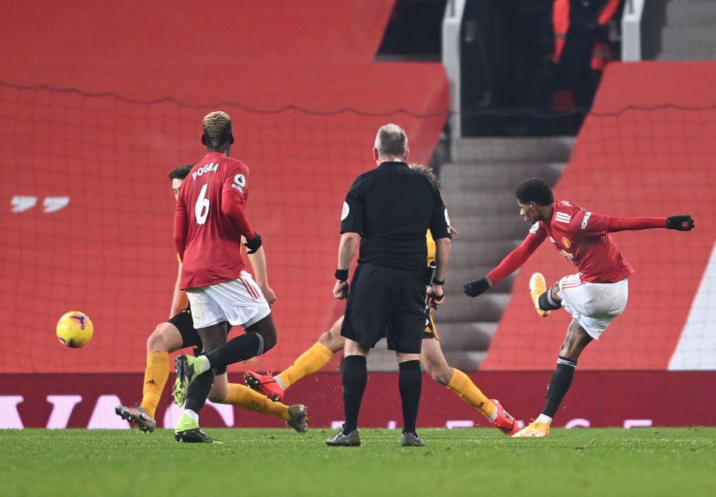 MANCHESTER, ENGLAND - DECEMBER 29: Manchester United's Marcus Rashford celebrates with teammate Paul Pogba after scoring his team's first goal during the Premier League match between Manchester United and Wolverhampton Wanderers at Old Trafford on December 29 2020 in Manchester, England.  The game will be played without fans, behind closed doors as a Covid-19 precautionary measure.  (Photo by Michael Regan / Getty Images)