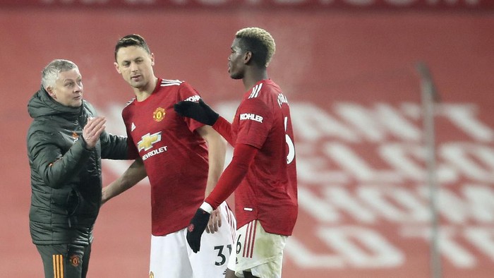 Manchester Uniteds manager Ole Gunnar Solskjaer greets Paul Pogba after the English Premier League soccer match between Manchester Utd and Wolverhampton Wanderers at Old Trafford stadium in Manchester, England, Tuesday,Dec. 29, 2020. (Martin Rickett, Pool via AP)