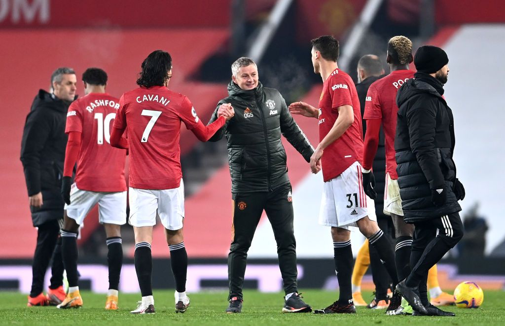 MANCHESTER, ENGLAND - DECEMBER 29: Ole Gunnar Solskjaer, Manager of Manchester United, Edinson Cavani, and Nemanja Matic celebrate following their team's victory in the Premier League match between Manchester United and Wolverhampton Wanderers at Old Trafford on December 29, 2020 in Manchester, England. The match will be played without fans, behind closed doors as a Covid-19 precaution. (Photo by Laurence Griffiths/Getty Images)