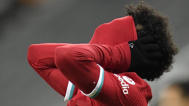 Liverpool's Mohamed Salah puts is shirt to his face after missing a chance to score during the English Premier League soccer match between Newcastle United and Liverpool at St James' Park stadium in Newcastle, England, Wednesday, Dec. 30, 2020. (Peter Powell/ Pool via AP)