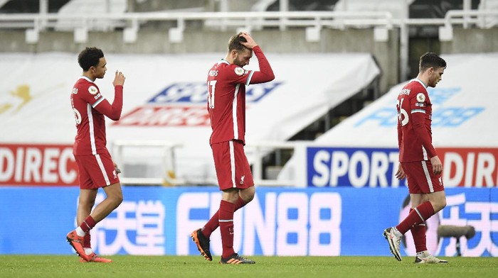 NEWCASTLE UPON TYNE, ENGLAND - DECEMBER 30: Andrew Robertson, Nathaniel Phillips and Trent Alexander-Arnold of Liverpool react as they walk off the pitch at full-time after the Premier League match between Newcastle United and Liverpool at St. James Park on December 30, 2020 in Newcastle upon Tyne, England. The match will be played without fans, behind closed doors as a Covid-19 precaution. (Photo by Peter Powell - Pool/Getty Images)