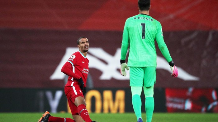 LIVERPOOL, ENGLAND - DECEMBER 27: Joel Matip of Liverpool interacts with Alisson Becker of Liverpool he kneels down injured during the Premier League match between Liverpool and West Bromwich Albion at Anfield on December 27, 2020 in Liverpool, England. A limited number of fans (2000) are welcomed back to stadiums to watch elite football across England. This was following easing of restrictions on spectators in tiers one and two areas only. (Photo by Nick Potts - Pool/Getty Images)