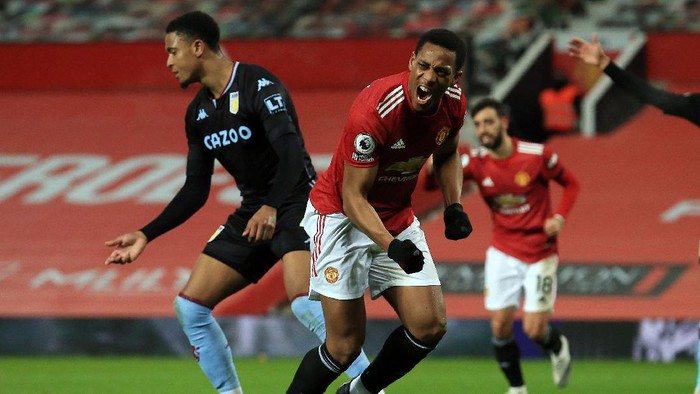 MANCHESTER, ENGLAND - JANUARY 01: Anthony Martial of Manchester United celebrates after scoring their teams first goal during the Premier League match between Manchester United and Aston Villa at Old Trafford on January 01, 2021 in Manchester, England. The match will be played without fans, behind closed doors as a Covid-19 precaution. (Photo by Lindsey Parnaby - Pool/Getty Images)