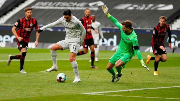 FRANKFURT AM MAIN, GERMANY - JANUARY 02: Nadiem Amiri of Bayer Leverkusen scores their team's first goal past Kevin Trapp of Eintracht Frankfurt during the Bundesliga match between Eintracht Frankfurt and Bayer 04 Leverkusen at Deutsche Bank Park on January 02, 2021 in Frankfurt am Main, Germany. Sporting stadiums around Germany remain under strict restrictions due to the Coronavirus Pandemic as Government social distancing laws prohibit fans inside venues resulting in games being played behind closed doors. (Photo by Ronny Wittek - Pool/Getty Images)