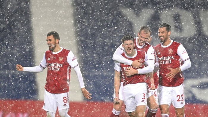 Arsenals Kieran Tierney, (3), celebrates with teammates after scoring the opening goal of the game during the English Premier League soccer match between West Bromwich Albion and Arsenal at the Hawthorns in Birmingham, England, Saturday, Jan. 2, 2021. (Michael Regan/ Pool via AP)