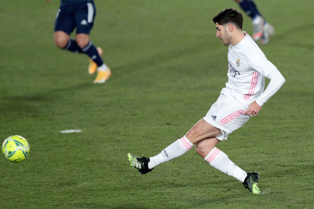 MADRID, SPAIN - JANUARY 02: Marco Asensio of Real Madrid celebrates after scoring their team's second goal during the La Liga Santander match between Real Madrid and RC Celta at Estadio Santiago Bernabeu on January 02, 2021 in Madrid, Spain. Sporting stadiums around Spain remain under strict restrictions due to the Coronavirus Pandemic as Government social distancing laws prohibit fans inside venues resulting in games being played behind closed doors. (Photo by Gonzalo Arroyo Moreno/Getty Images)