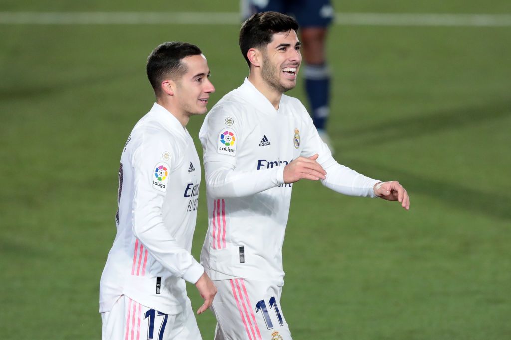 MADRID, SPAIN - JANUARY 02: Marco Asensio of Real Madrid celebrates with teammate Lucas Vazquez after scoring their team's second goal during the La Liga Santander match between Real Madrid and RC Celta at Estadio Santiago Bernabeu on January 02, 2021 in Madrid, Spain. Sporting stadiums around Spain remain under strict restrictions due to the Coronavirus Pandemic as Government social distancing laws prohibit fans inside venues resulting in games being played behind closed doors. (Photo by Gonzalo Arroyo Moreno/Getty Images)
