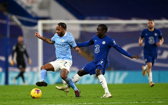 Chelsea, Manchester City LONDON, ENGLAND - JANUARY 03: Raheem Sterling of Manchester City is challenged by N'Golo Kante of Chelsea during the Premier League match between Chelsea and Manchester City at Stamford Bridge on January 03, 2021 in London, England. The match will be played without fans, behind closed doors as a Covid-19 precaution. (Photo by Shaun Botterill/Getty Images)