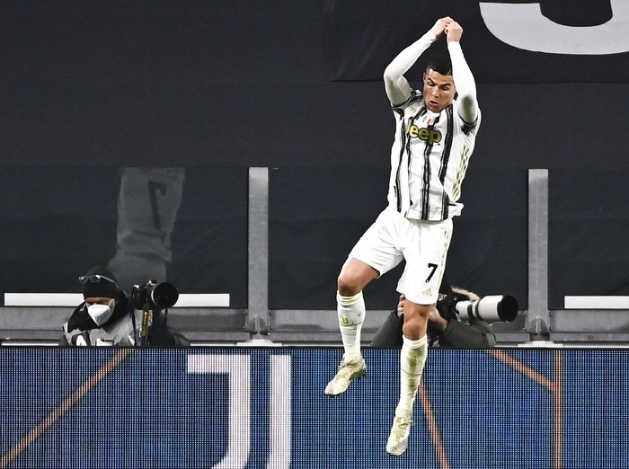 Cristiano Ronaldo of Juventus celebrates after scoring 3-0 during the Italian Serie A soccer match between Juventus and Udinese at the Allianz Stadium in Turin, Italy, Sunday Jan. 3, 2021. (Marco Alpozzi/LaPresse via AP)