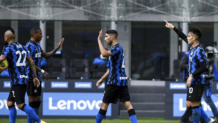 Inter MIlans Lautaro Martinez, center, celebrates after scoring during the Serie A soccer match between Inter Milan and Crotone at the San Siro Stadium in Milan, Italy, Sunday, Jan. 3, 2021. (Piero Cruciatti /LaPresse via AP)