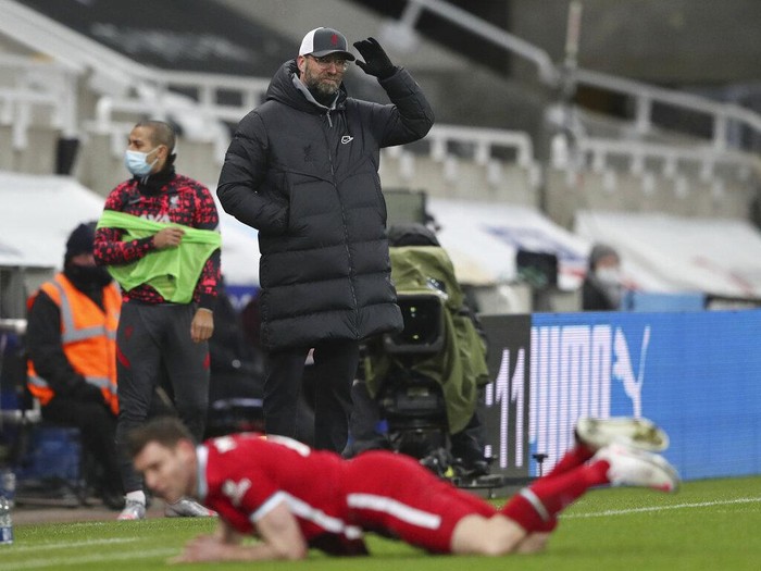 Liverpools manager Jurgen Klopp watches as his player Liverpools James Milner falls following a tackle during the English Premier League soccer match between Newcastle United and Liverpool at St James Park stadium in Newcastle, England, Wednesday, Dec. 30, 2020. (AP Photo/Scott Heppell)