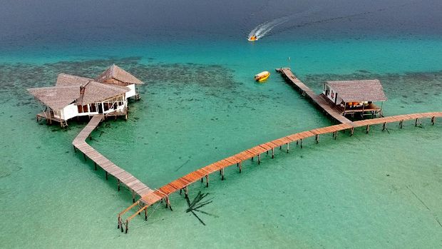 Foto aerial kondisi jembatan penghubung antar vila yang rusak di objek wisata Pulo Cinta Ecoresort, Kabupaten Boalemo, Gorontalo, Senin (4/1/2021). Sejumlah fasilitas dan jembatan penghubung di destinasi wisata unggulan tersebut rusak dan hancur diterjang badai untuk pertama kalinya sejak dibuka pada tahun 2016, pihak pengelola mengaku mengalami kerugian hingga Rp.500 juta akibat kejadian tersebut. ANTARA FOTO/Adiwinata Solihin/hp.