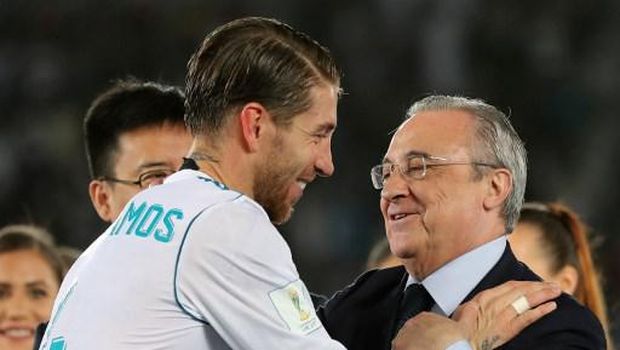 Real Madrid's captain Sergio Ramos (L) shakes hands with Real Madrid's President Florentino Perez after they won the FIFA Club World Cup final football match against Gremio FBPA at the Zayed Sports City Stadium in Abu Dhabi on December 16, 2017. - Real Madrid defeated Gremio 1-0 to lift the FIFA Club World Cup for the third time. (Photo by KARIM SAHIB / AFP)