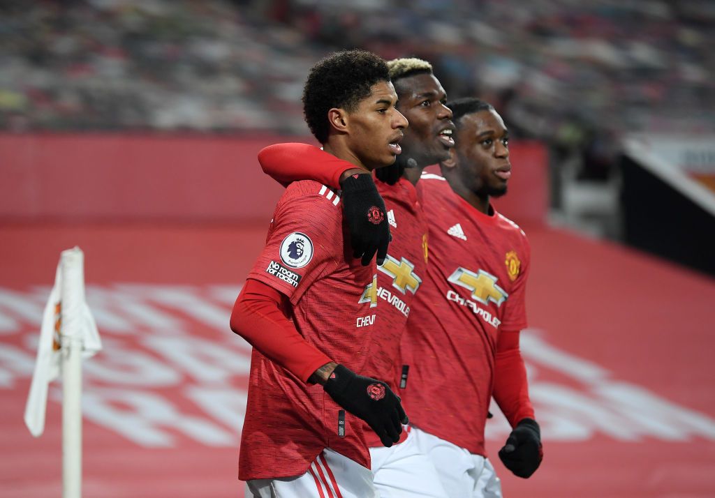 MANCHESTER, ENGLAND - DECEMBER 29: Marcus Rashford of Manchester United celebrates with teammates Paul Pogba and Aaron Wan-Bissaka after scoring his team's first goal during the Premier League match between Manchester United and Wolverhampton Wanderers at Old Trafford on December 29, 2020 in Manchester, England. The match will be played without fans, behind closed doors as a Covid-19 precaution. (Photo by Michael Regan/Getty Images)