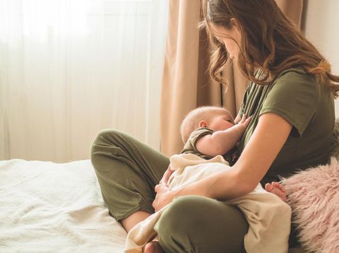 happy family photo of mother and daughter breastfeeding her baby