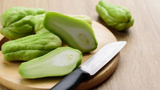 Chayote squash or Mirlition squash on cutting wooden board preparing for cooking