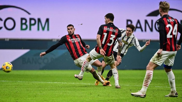 Juventus Italian forward Federico Chiesa (Rear R) shoots to score his second goal during the Italian Serie A football match AC Milan vs Juventus on January 6, 2021 at the San Siro stadium in Milan. (Photo by MIGUEL MEDINA / AFP)