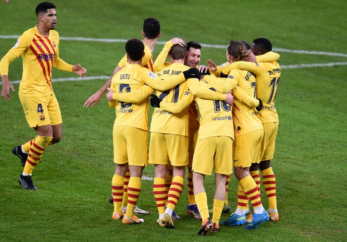 BILBAO, SPAIN - JANUARY 06: Pedri of Barcelona  celebrates with Lionel Messi of Barcelona and team mates after scoring his sides first goal during the La Liga Santander match between Athletic Club and FC Barcelona at Estadio de San Mames on January 06, 2021 in Bilbao, Spain. Sporting stadiums around Spain remain under strict restrictions due to the Coronavirus Pandemic as Government social distancing laws prohibit fans inside venues resulting in games being played behind closed doors. (Photo by Juan Manuel Serrano Arce/Getty Images)
