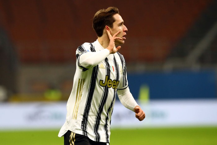 MILAN, ITALY - JANUARY 06: Federico Chiesa of Juventus F.C. celebrates after scoring their teams second goal during the Serie A match between AC Milan and Juventus at Stadio Giuseppe Meazza on January 06, 2021 in Milan, Italy. Sporting stadiums around Italy remain under strict restrictions due to the Coronavirus Pandemic as Government social distancing laws prohibit fans inside venues resulting in games being played behind closed doors. (Photo by Marco Luzzani/Getty Images)