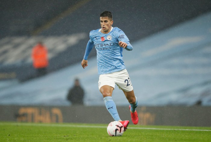 MANCHESTER, ENGLAND - NOVEMBER 08: Joao Cancelo of Manchester City on the ball during the Premier League match between Manchester City and Liverpool at Etihad Stadium on November 08, 2020 in Manchester, England. Sporting stadiums around the UK remain under strict restrictions due to the Coronavirus Pandemic as Government social distancing laws prohibit fans inside venues resulting in games being played behind closed doors. (Photo by Clive Brunskill/Getty Images)