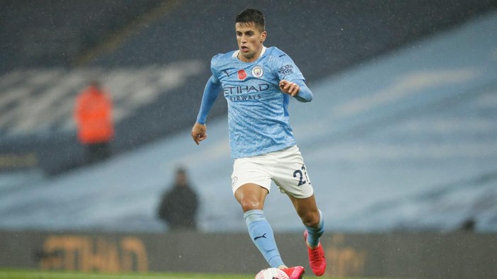 MANCHESTER, ENGLAND - NOVEMBER 08: Joao Cancelo of Manchester City on the ball during the Premier League match between Manchester City and Liverpool at Etihad Stadium on November 08, 2020 in Manchester, England. Sporting stadiums around the UK remain under strict restrictions due to the Coronavirus Pandemic as Government social distancing laws prohibit fans inside venues resulting in games being played behind closed doors. (Photo by Clive Brunskill/Getty Images)