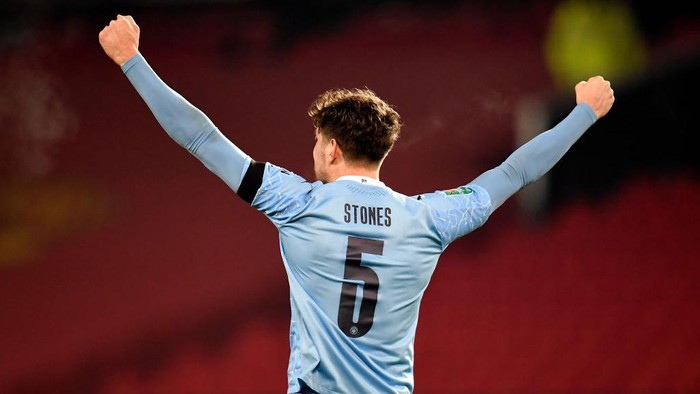MANCHESTER, ENGLAND - JANUARY 06: John Stones of Manchester City celebrates at the final whistle during the Carabao Cup Semi Final match between Manchester United and Manchester City at Old Trafford on January 06, 2021 in Manchester, England. The match will be played without fans, behind closed doors as a Covid-19 precaution. (Photo by Peter Powell - Pool/Getty Images)
