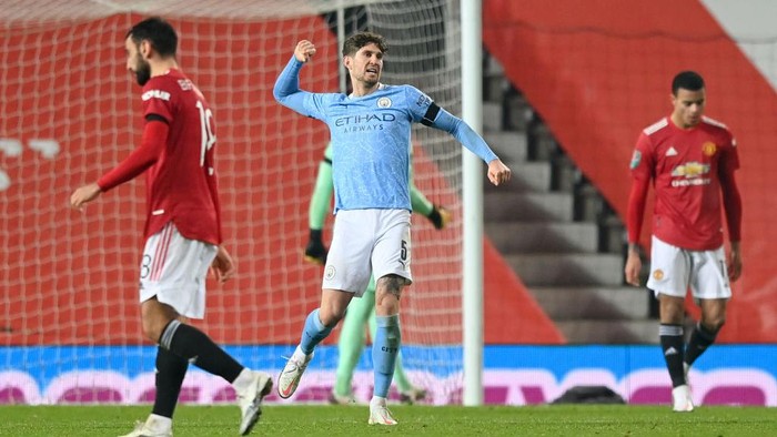 MANCHESTER, ENGLAND - JANUARY 06: John Stones of Manchester City celebrates at the final whistle during the Carabao Cup Semi Final match between Manchester United and Manchester City at Old Trafford on January 06, 2021 in Manchester, England. The match will be played without fans, behind closed doors as a Covid-19 precaution. (Photo by Shaun Botterill/Getty Images)