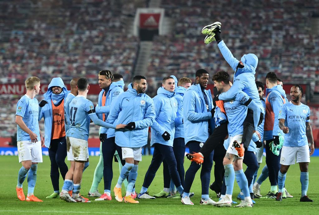 MANCHESTER, ENGLAND - JANUARY 06: Manchester City team celebrate after their victory in the Carabao Cup Semi Final match between Manchester United and Manchester City at Old Trafford on January 06, 2021 in Manchester, England. The match will be played without fans, behind closed doors as a Covid-19 precaution. (Photo by Peter Powell - Pool/Getty Images)