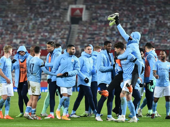 MANCHESTER, ENGLAND - JANUARY 06: Manchester City team celebrate after their victory in the Carabao Cup Semi Final match between Manchester United and Manchester City at Old Trafford on January 06, 2021 in Manchester, England. The match will be played without fans, behind closed doors as a Covid-19 precaution. (Photo by Peter Powell - Pool/Getty Images)