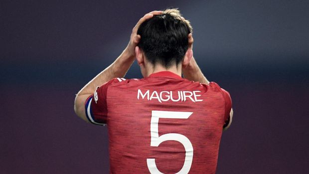 Manchester United's Harry Maguire reacts reacts after Manchester City goal during the English League Cup semifinal soccer match between Manchester United and Manchester City at Old Trafford in Manchester, England, Wednesday, Jan. 6, 2021. (Peter Powell/Pool via AP)