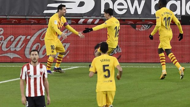 Barcelona's Lionel Messi, top left, celebrates with teammates after scoring during the Spanish La Liga soccer match between Athletic Bilbao and Barcelona at San Mames stadium in Bilbao, Spain, Wednesday, Jan. 6, 2021.(AP Photo/Alvaro Barrientos)