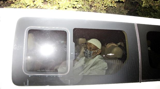 Islamic cleric Abu Bakar Bashir sits inside a van as he leaves upon his release from Gunung Sindur Prison in Bogor, West Java, Indonesia, Friday, Jan. 8, 2021. The convicted firebrand cleric who inspired the Bali bombers and other violent extremists walked free from prison Friday after completing his sentence for funding the training of Islamic militants. (AP Photo/Aditya Irawan)