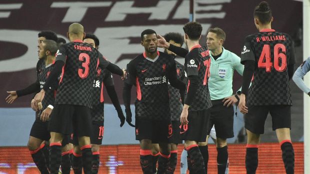 Liverpool's Georginio Wijnaldum, center, celebrates after scoring his side's second goal, during the FA Cup 3rd round soccer match between Aston Villa and Liverpool at Villa Park stadium in Birmingham, England, Friday, Jan. 8, 2021. (AP Photo/Rui Vieira)