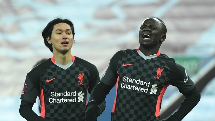 Liverpool BIRMINGHAM, ENGLAND - JANUARY 08: Sadio Mane of Liverpool (R) celebrates after scoring their sides first goal next to Takumi Minamino during the FA Cup Third Round match between Aston Villa and Liverpool at Villa Park on January 08, 2021 in Birmingham, England. The match will be played without fans, behind closed doors as a Covid-19 precaution. (Photo by Shaun Botterill/Getty Images)