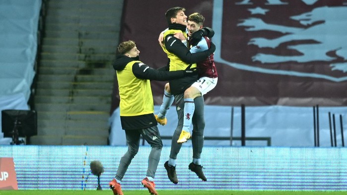 BIRMINGHAM, ENGLAND - JANUARY 08: Louie Barry of Aston Villa celebrates after scoring their sides first goal with players from the bench during the FA Cup Third Round match between Aston Villa and Liverpool at Villa Park on January 08, 2021 in Birmingham, England. The match will be played without fans, behind closed doors as a Covid-19 precaution. (Photo by Shaun Botterill/Getty Images)