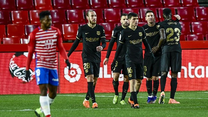 Barcelonas Lionel Messi, second right, celebrates after scoring his sides second goal during the Spanish La Liga soccer match between Granada and FC Barcelona at the Los Carmenes stadium in Granada, Spain, Saturday, Jan. 9, 2021. (AP Photo/Jose Breton)