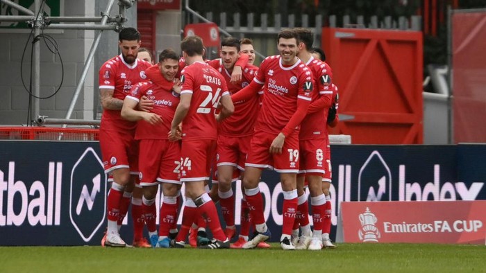 CRAWLEY, ENGLAND - JANUARY 10: Nicholas Tsaroulla of Crawley Town celebrates with Jordan Tunnicliffe and team mates after scoring their sides first goal during the FA Cup Third Round match between Crawley Town and Leeds United at The Peoples Pension Stadium on January 10, 2021 in Crawley, England. Sporting stadiums around England remain under strict restrictions due to the Coronavirus Pandemic as Government social distancing laws prohibit fans inside venues resulting in games being played behind closed doors. (Photo by Mike Hewitt/Getty Images)