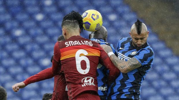 Roma's Chris Smalling, left, and Inter Milan's Arturo Vidal jump for the ball during a Serie A soccer match between Roma and Inter Milan, at Rome's Olympic Stadium, Sunday, Jan. 10, 2021. (AP Photo/Andrew Medichini)