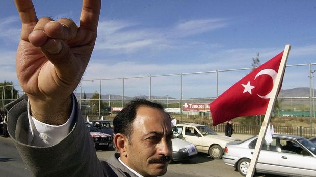 NICOSIA, CYPRUS - DECEMBER 13:  Supporters of the nationalist Rightist Party make the sign of the Gray Wolves December 13, 2003 in Nicosia, Cyprus. Turkish Cypriots will go to the polls December 14 for crucial parliamentary elections in which they will be asked to choose between parties that supporting hardline action or U.M. backed negotiations. (Photo by Milos Bicanksi/Getty Images)