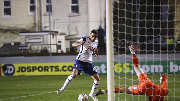 Tottenham's Carlos Vinicius scores his side's first goal passing Marine's goalkeeper Bayleigh Passant, right, during the English FA Cup third round soccer match between Marine and Tottenham Hotspur at Rossett Park stadium in Crosby, Liverpool, Sunday, Jan. 10, 2021. (Clive Brunskill/Pool via AP)