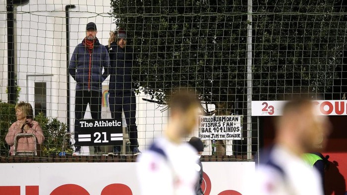 CROSBY, ENGLAND - JANUARY 10: A spectator is seen holding a cardboard cut-out of Liverpools manager Jurgen Klopp during the FA Cup Third Round match between Marine and Tottenham Hotspur at Rossett Park on January 10, 2021 in Crosby, England. Sporting stadiums around England remain under strict restrictions due to the Coronavirus Pandemic as Government social distancing laws prohibit fans inside venues resulting in games being played behind closed doors. (Photo by Martin Rickett - Pool/Getty Images)